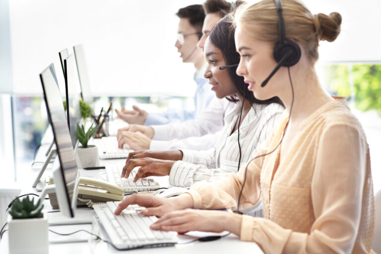 Contact center operators with headsets assisting customers, business and marketing solutions.