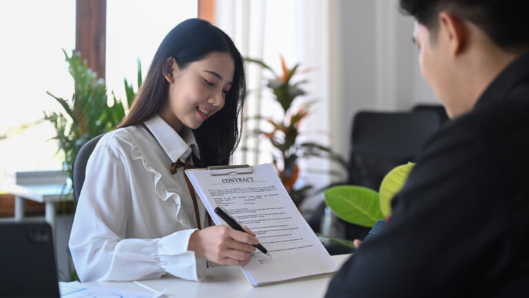 Customer signing rental lease contract, car dealership agreement.