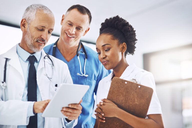 Healthcare professionals reviewing tablet, exploring careers in health care.